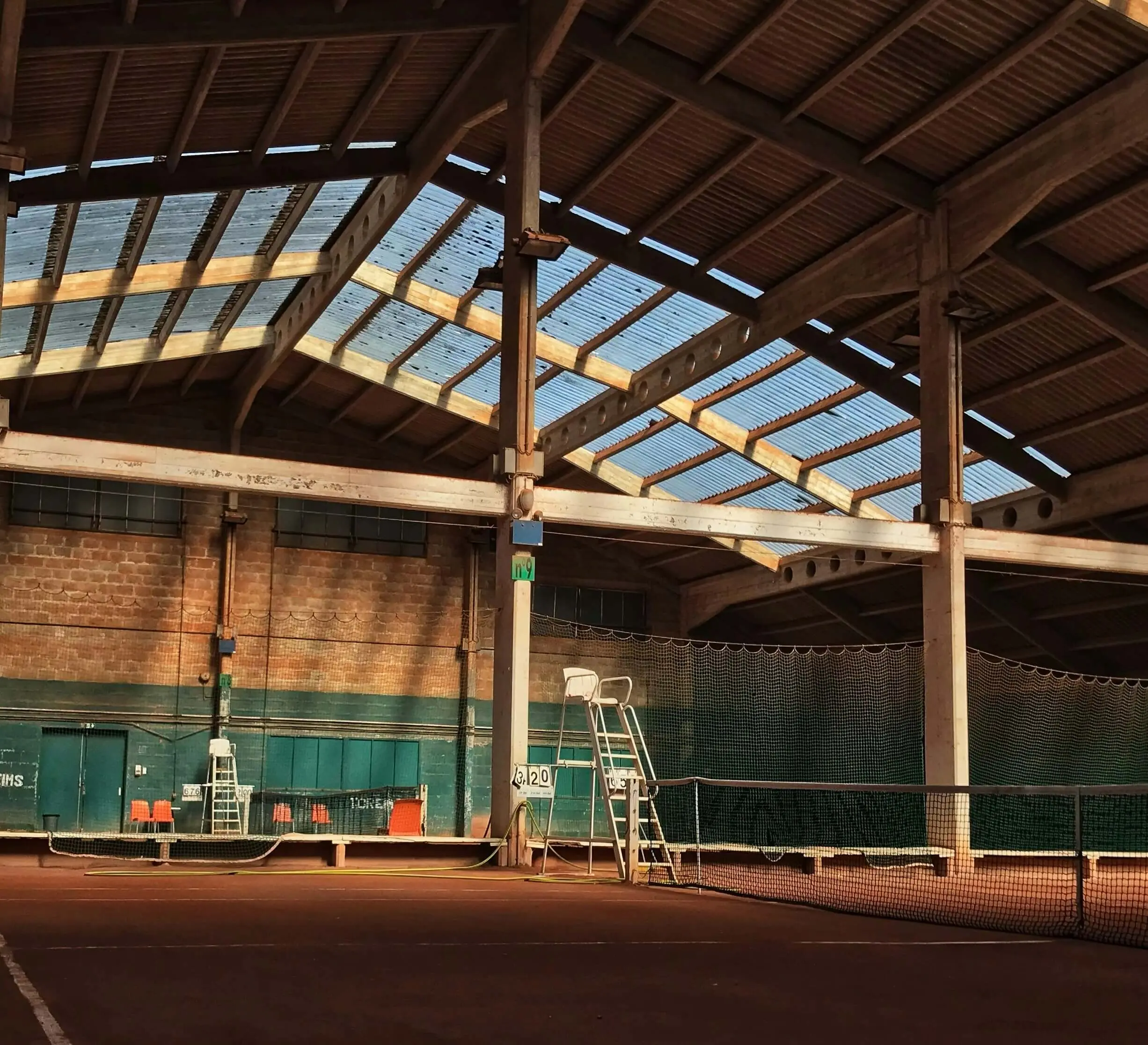 View of an indoor tennis court, representing the facilities and environments where Evolve delivers high-quality science based tennis training and supports tennis club development plans.