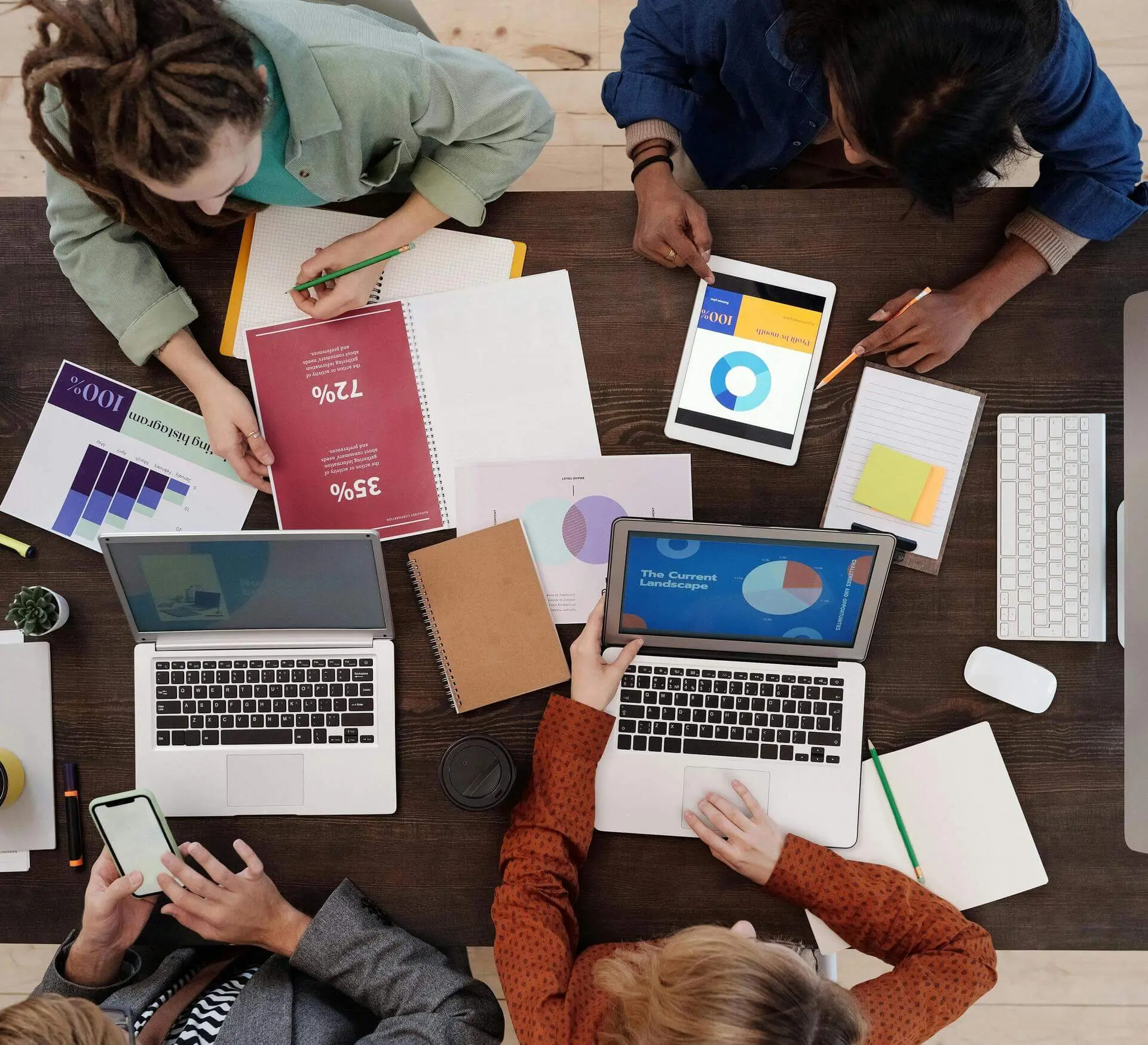 Group of professionals reviewing data and plans, symbolizing the executive coaching and strategic support provided for tennis club development and tennis coach development.